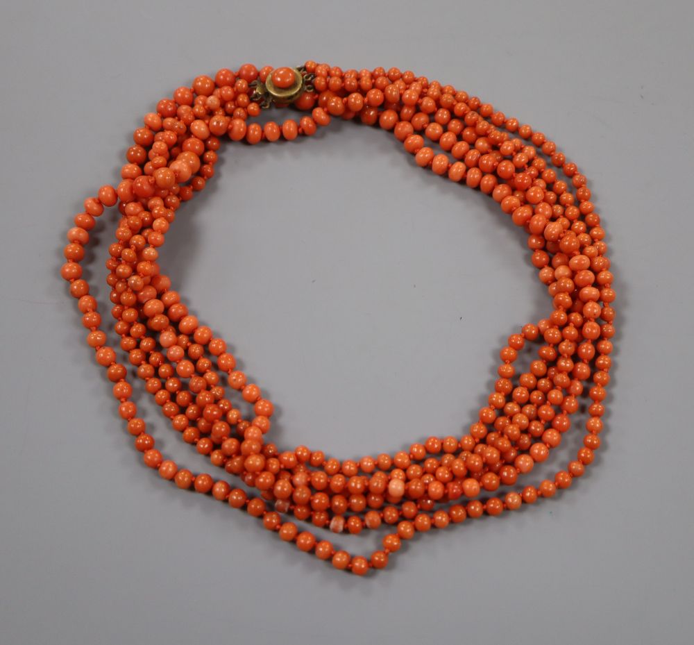A triple strand graduated coral bead necklace, with gilt metal clasp, 86cm, gross weight 81 grams.